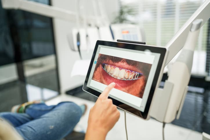 Dentist reviewing a patient's teeth during an evaluation